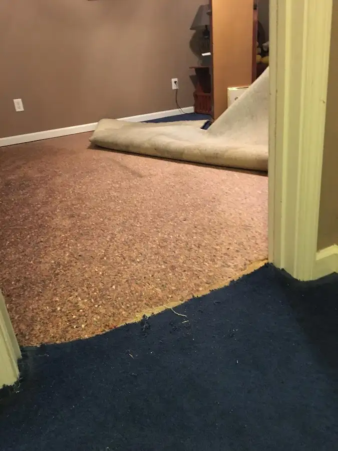 Carpet pad removal revealing water damage during Drying & Dehumidification in East Los Angeles